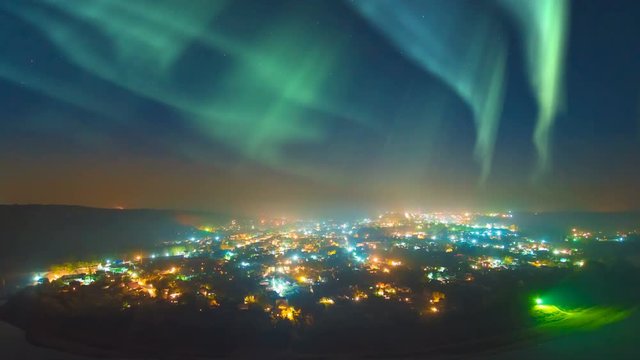 The beautiful northern light over the night city. time lapse