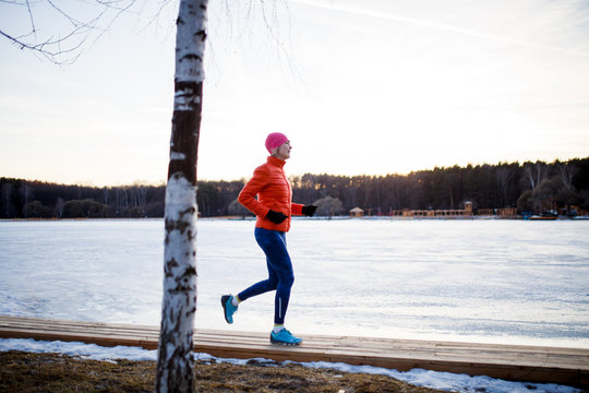 Picture of young athlete blonde at morning exercises in winter