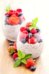 Chia. Superfoods breakfast with Chia seed pudding and berries in a glass over wooden rustic background. Health concept, omega 3 product..