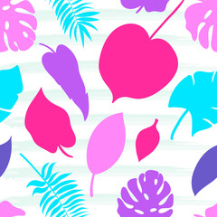 Seamless pattern of tropical leaves on the watercolor stripped background.