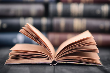 Old empty notebook on the black wooden background.