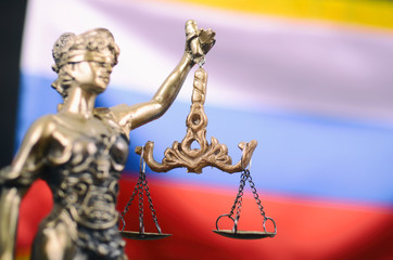 Scales of Justice, Justitia, Lady Justice in front of the Russian flag in the background.