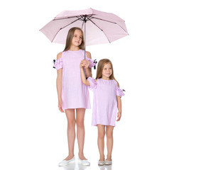 Two girls are standing under umbrellas.