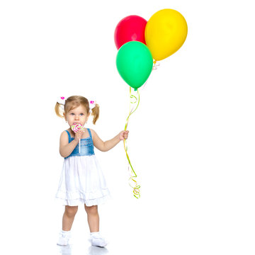 Little girl is playing with a balloon