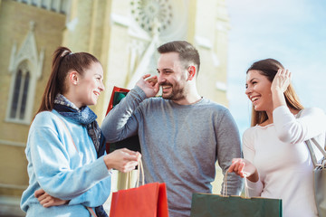 Happy friends shopping. Young friends enjoying shopping in the city.