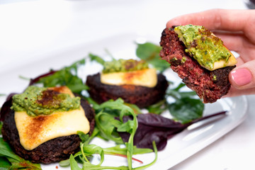 Healthy vegetarian potato patties with carrots, broccoli, bell pepper, green peas and onions with roque and basil sauce.