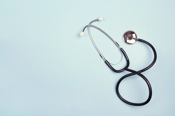 Top view of stethoscope on blue background. Flat lay and copy space. - obrazy, fototapety, plakaty
