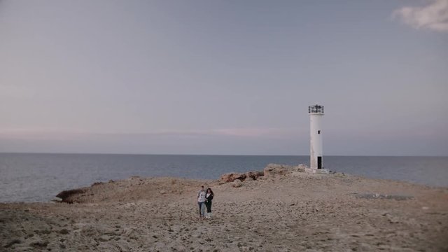 beautiful couple love each other in front of a lighthouse