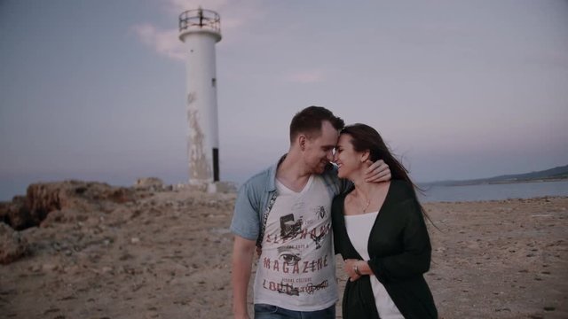 beautiful couple love each other in front of a lighthouse