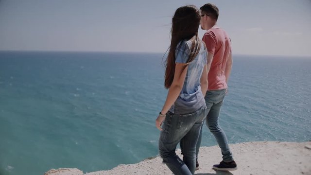 Loving happy and very beautiful couple walking near the ocean