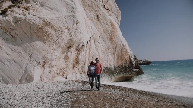 Loving happy and very beautiful couple walking near the ocean