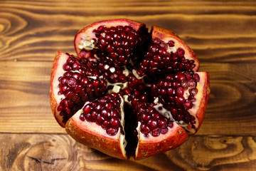 Ripe pomegranate fruit on wooden table