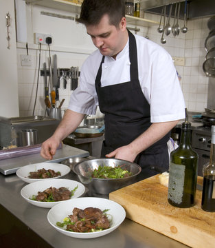 Professional Chef At Work In A Restaurant Kitchen