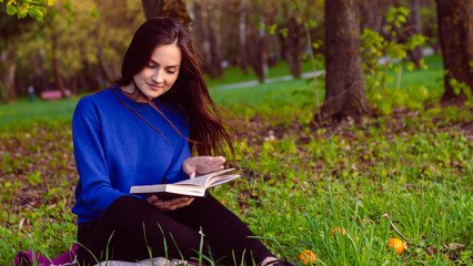 Girl reading book in park