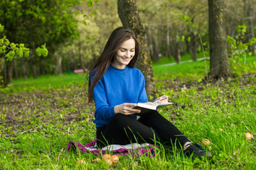 Girl reading book in park
