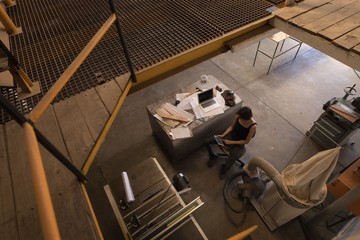 Female welder using digital tablet