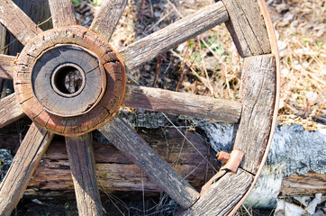 Old wooden cart wheel. The concept of outdated technologies, ecotourism
