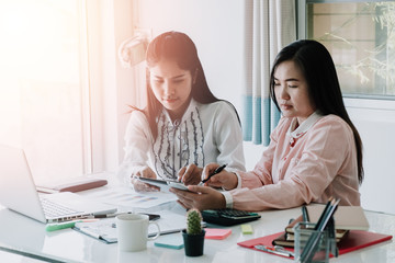 Two colleagues discussing data with new modern computer
