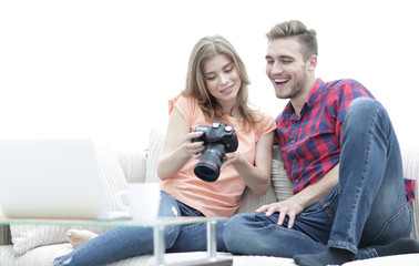 happy young couple checks photos on photos the camera