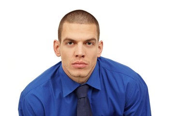 Portrait of young man at blue shirt and tie with front view on white backgound in studio 