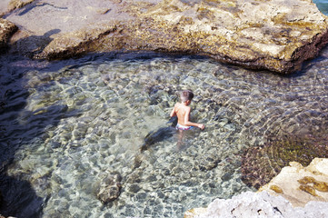 A boy bathing at the seashore
