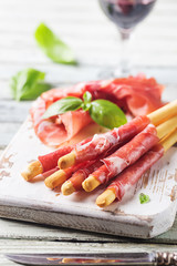 Bread sticks grissini with prosciutto