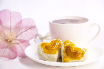 Heart shape cookies with cashew nut or Singapore Cookie and coffee cup on the white table background for valentines day element concept design. With copy space for text.