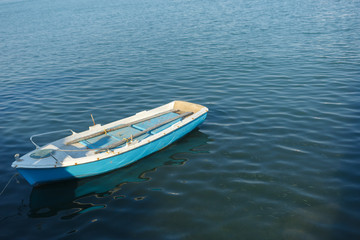 Naklejka premium Fishing boat bobs on the waves