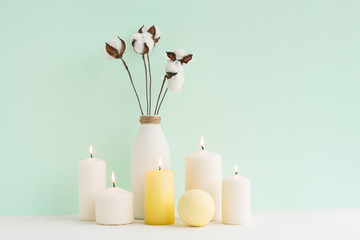 Spa composition. Candles, cotton flowers on white background. Flat lay, mock up. top view