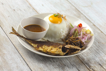 fried fish with rice with spices and curry