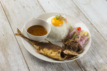 fried fish with rice with spices and curry