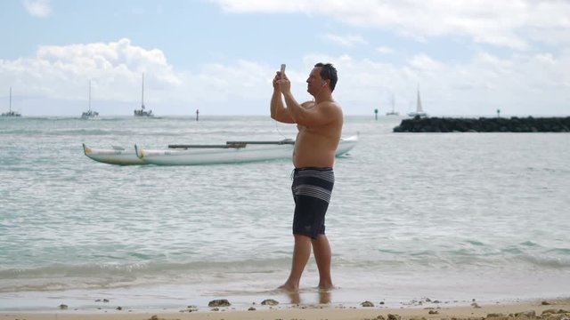Professional video of man taking a selfie in Honolulu Hawaii in 4k slow motion 60fps