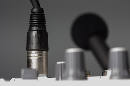 Mikrofonkabel eingesteckt in Audio-Interface mit Phantomspeisung, Mikrofon im Hintergrund
