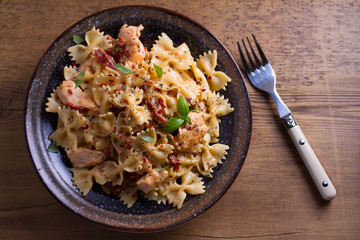 Sun dried tomato pasta with chicken and basil in creamy mozzarella sauce. View from above, top studio shot