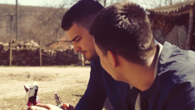 Two guys eat ice cream on the street