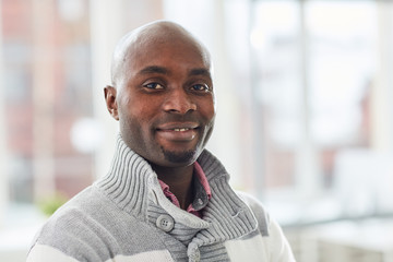 Portrait of young African casual businessman smiling at camera