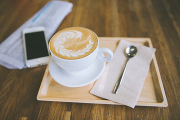 cup of coffee tablet and smart phone on wooden table