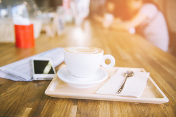cup of coffee tablet and smart phone on wooden table