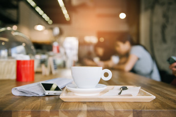 cup of coffee tablet and smart phone on wooden table