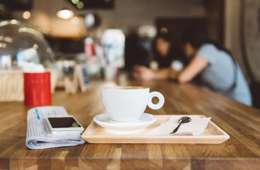 cup of coffee tablet and smart phone on wooden table