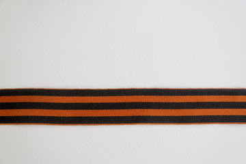 Saint George ribbon with order of the Great Patriotic and red carnations on gray