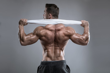 Strong Athletic Man Fitness Model posing back muscles, triceps, latissimus
