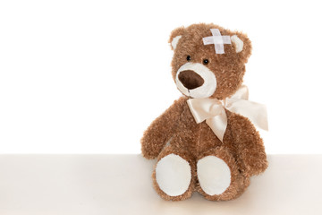 Teddy bear with sticking plaster