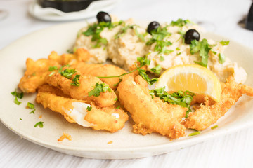 fried squid with lemon on white dish