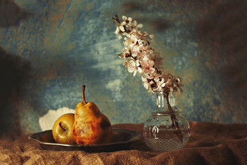 still life with pears in the setting sun, a glass vase and soft shades