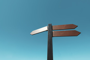 blank wooden sign against blue sky