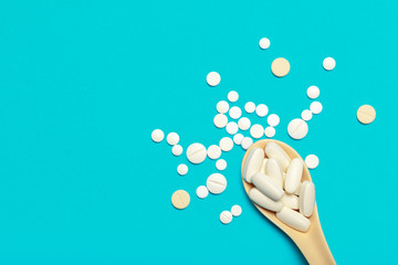 Pills are scattered over a blue background