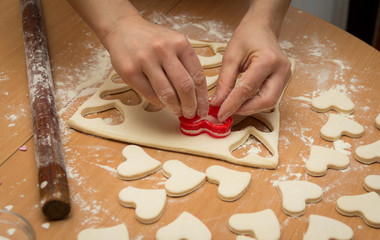 The process of making cookies. Raw dough, rolling pin and baking star forms