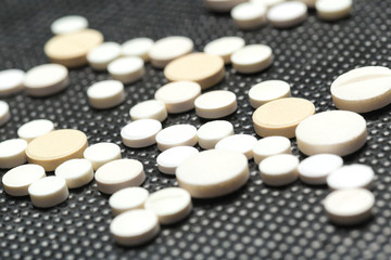tablets and pills on dark background