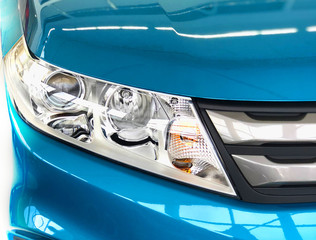Headlight of the modern blue car